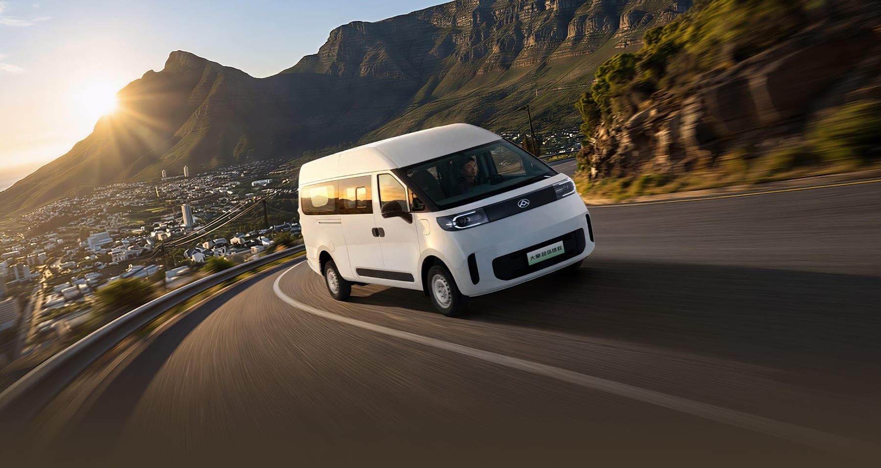 2026 MAXUS Dana Super EREV Van — Range-Extender Electric Cargo Van for export, front three-quarter view on a coastal road