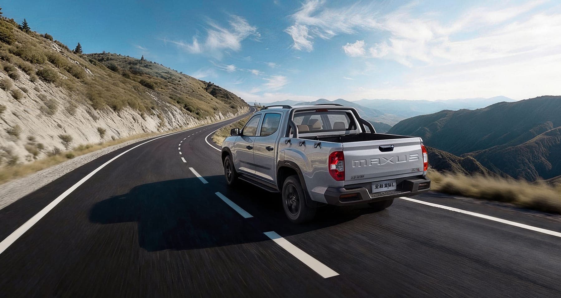 2026 MAXUS Interstellar L New Generation — Double Cab Diesel Pickup Truck for export, rear three-quarter view on a mountain road